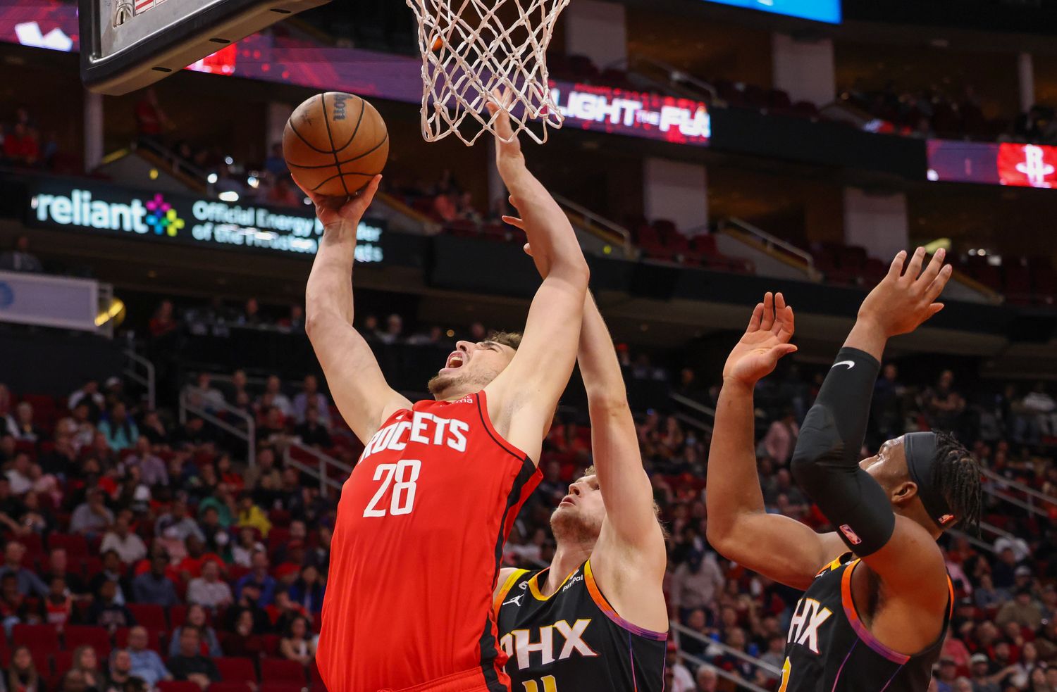 Rockets center Alperen Sengun shoots against Phoenix Suns center Jock Landale (11) in the second half at Toyota Center.
